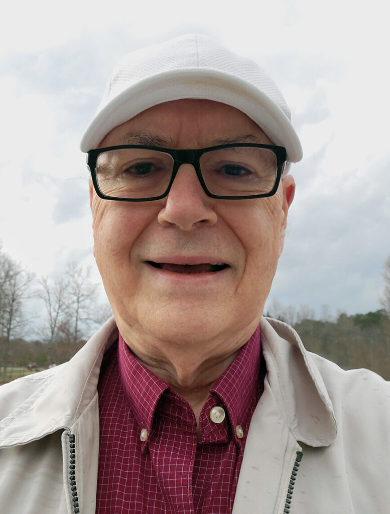 Terry Dunkle outdoors in white cap and khaki jacket