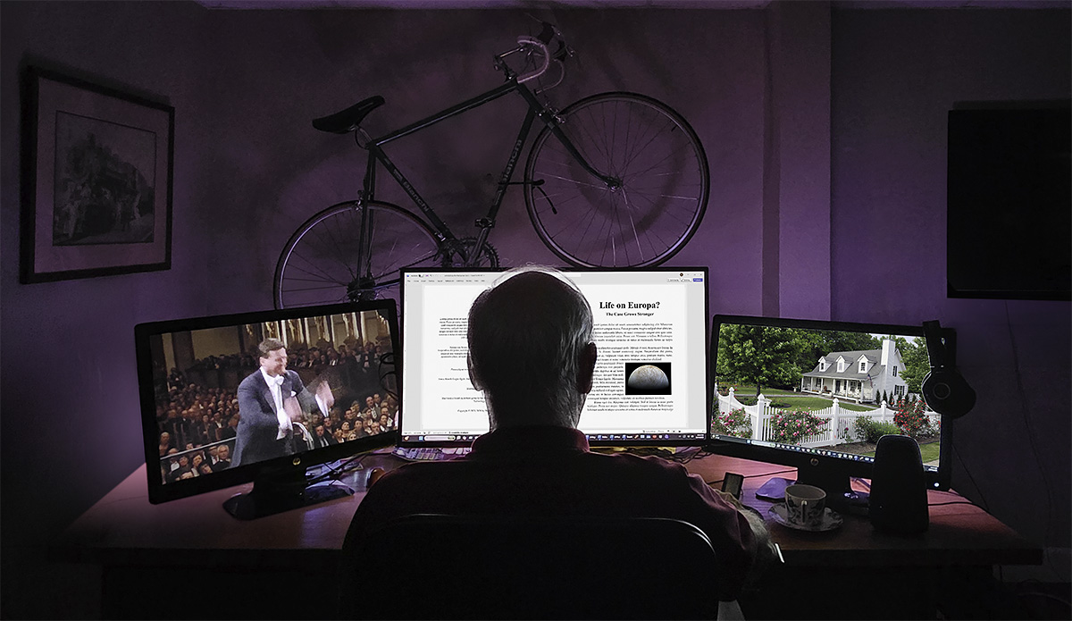 Terry Dunkle, working at three monitors in his home office